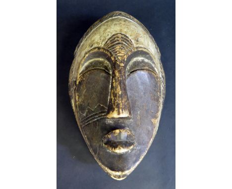 A West African Gabon Carved and Painted Light Wood Spirit Mask, 31cm 