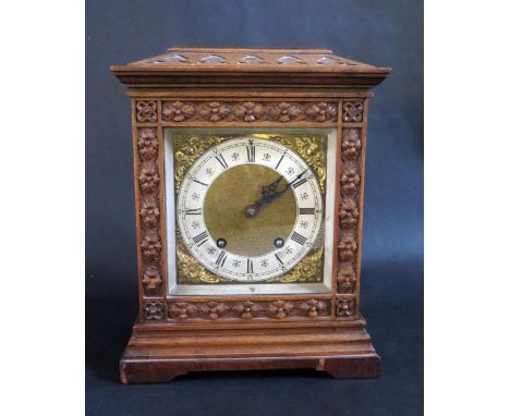 Antique Mantle Clock in Carved Wood Case.  Brass Dial, 14cm with silvered Chapter Ring.  Striking Movement marked AGU Lenzkir