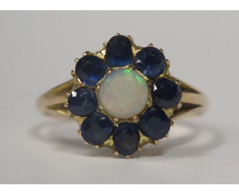 An Antique Opal and Sapphire Cluster Ring in an unmarked yellow gold setting, size P.5, 3.3g