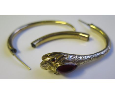 A Damaged Unmarked Gold and Cabochon Garnet Serpent Bangle, 14.1g gross 