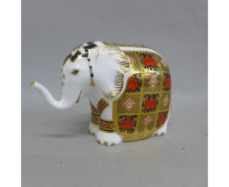 A Royal Crown Derby paperweight - Elephant, 1128 pattern, trunk raised, missing stopper