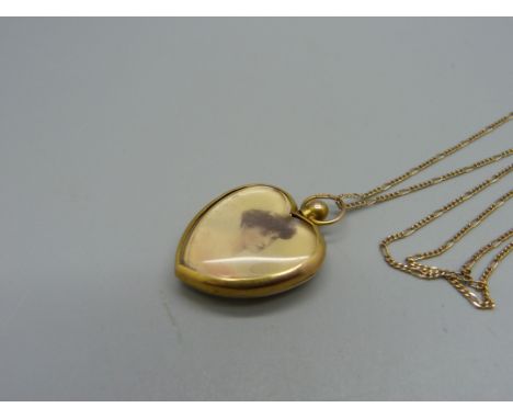 A vintage early 20th Century 9ct gold heart shaped photograph pendant on a fine 9ct gold chain, chain 2.1g, pendant 22mm wide
