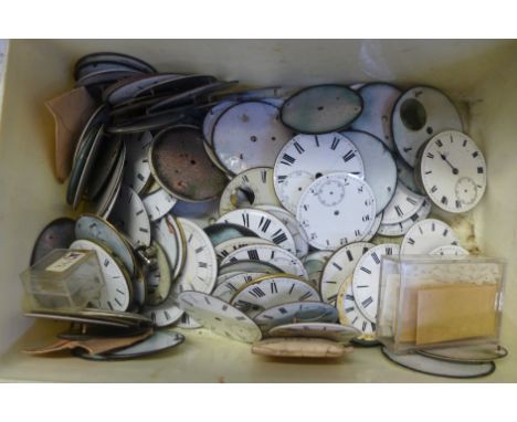 A tub of enamel pocket watch dials 