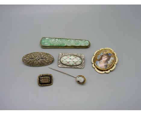 A carved jade brooch, 85mm, a mourning brooch, three other brooches and a cameo stick pin