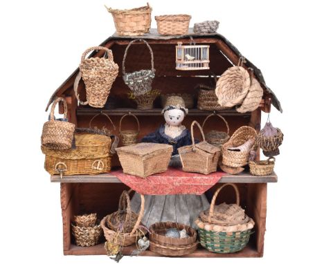 A sweet and early miniature wooden painted Basket stall, German 1840s, the papered exterior with ornate hand painted flower a