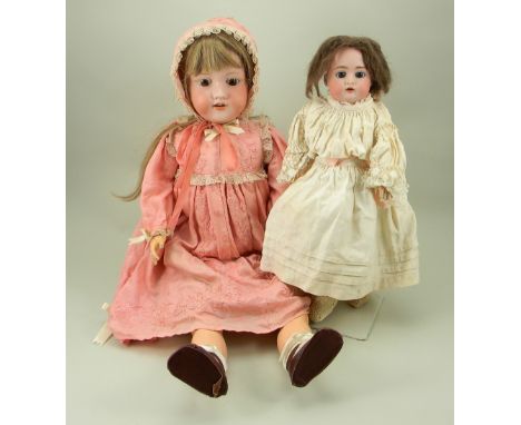 A.M 390 bisque head doll, circa 1910, with weighted brown glass eyes, open mouth, upper teeth and later long brown wig, on a 