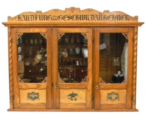 A fine wooden Grocery store, German 1890s, the stained wooden shop with three glazed opening doors to front each with transfe