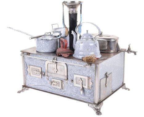 An enamelled tinplate child’s cooking stove, German circa 1890, the grey enamelled stove with embossed decoration, mounted on