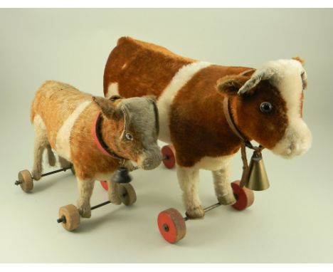 A Steiff Cow on wheels, 1920s, button to left ear, straw filled brown and white mohair with felt backed boot button eyes, lea