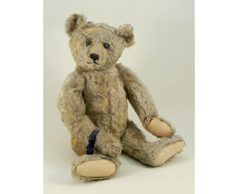 A fine Steiff golden mohair Teddy bear, circa 1909, the straw stuffed bear with black boot button eyes, black stitched nose a