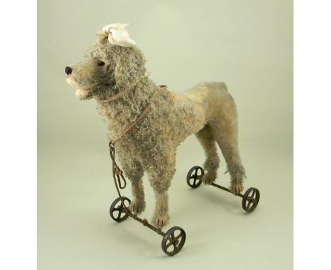 Large Steiff Poodle dog on metal wheels, German circa 1911, standing on all fours with button to left ear, the straw filled w