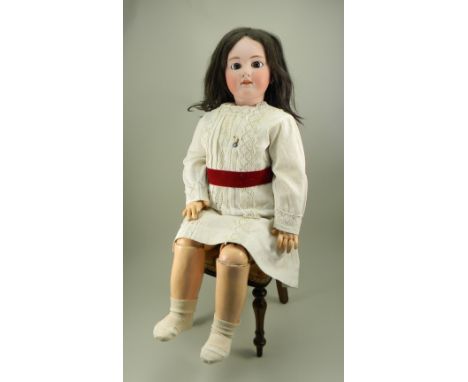Large Simon &amp; Halbig DEP bisque head doll, German for the French market, circa 1910, with weighted brown glass eyes, pain