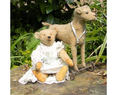 A Steiff toy dog on wheels and Teddy bear, 1910-20s, dog with button to left ear, boot button eyes, stitched nose and mouth a