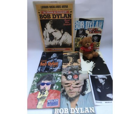 A collection of Bob Dylan memorabilia including various books, badges, blanket and other items.