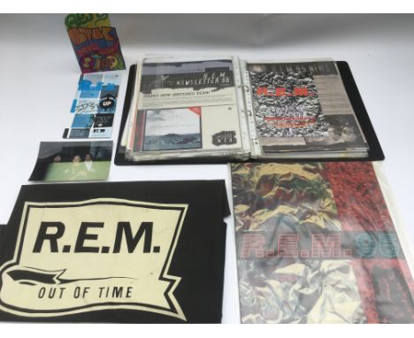 A collection of REM related items including a signed gig ticket from 1999, a binder of fanclub materials, an 'Out Of Time' pi