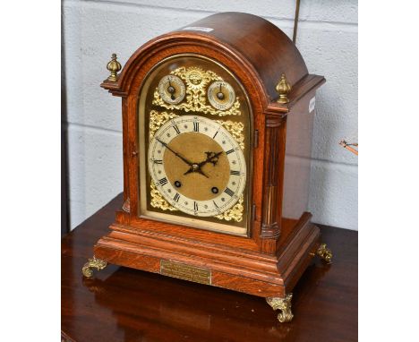 A German Oak Quarter Striking Mantel Clock, circa 1900, the case with arch pediment, stop brass fluted inset side pillasters,