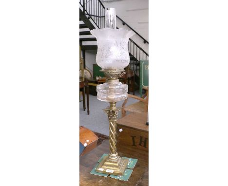 A Victorian Oil Lamp, with etched glass shade, flat cut reservoit and on brass Corinthian twist column pedestal, 67cm high