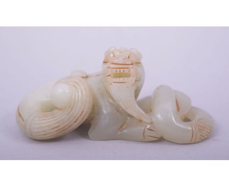 A CHINESE JADE CARVING of a lion dog and serpent, 8.5cm long.