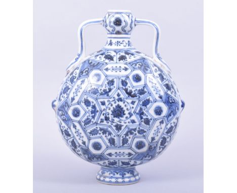 A CHINESE BLUE AND WHITE PORCELAIN TWIN HANDLE MOON FLASK, the body painted central with lotus and surrounded by various foli