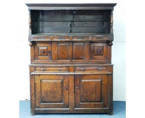 An early 18thC oak Tridarn, dated 1734, the canopy with ogive cornice and turned side supports, the central  section with twi