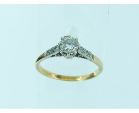 A single stone diamond Ring, with three diamond points on each shoulder, the shank in 18ct yellow gold, size R.