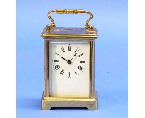 A French brass carriage clock, with enamel dial, 5½in (14cm) high, handle up.