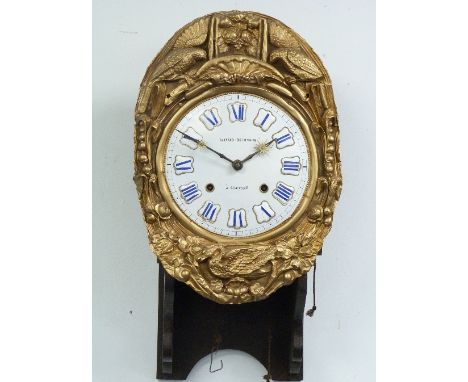 A French Comptoise Clock, the enamel dial signed, 'Raynaud Roumagoux, a Charesat', with heavily embossed brass surround, moun