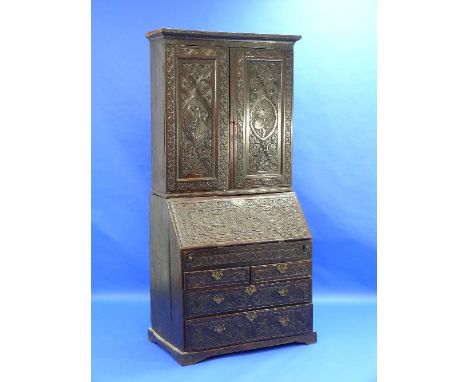 A Georgian oak Bureau Bookcase, the fall front enclosing a fitted interior with drawers, pigeon holes and secret compartments