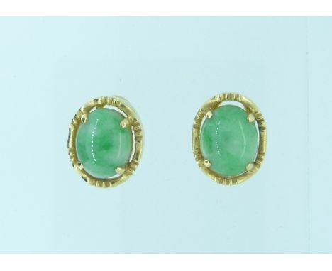 A pair of oval Jade Earrings, claw set in a yellow gold mount, the reverse with pin and clip fittings, marked "750".