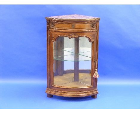 A French walnut bow-front corner display Case, the marble top above a frieze drawer and glazed door enclosing a shelf, 25½in 