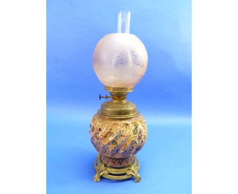 A Victorian ceramic and brass Oil Lamp, the spiral fluted spherical pottery base hand decorated in coloured enamel paints, up