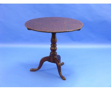 A Georgian oak circualr tilt top Table, upon a tripod base, 33in (84cm) wide.