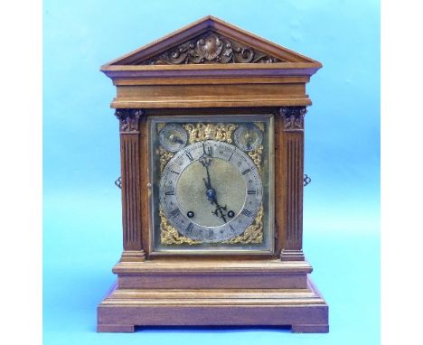 An Edwardian walnut mantel Clock, of architectural form with square brass dial and silvered chapter ring, the 8-day movement 