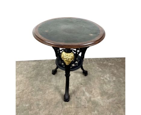 Vintage round 3 legged English pub table with wooden top and cast iron base. The wooden top is quite worn but the cast iron b