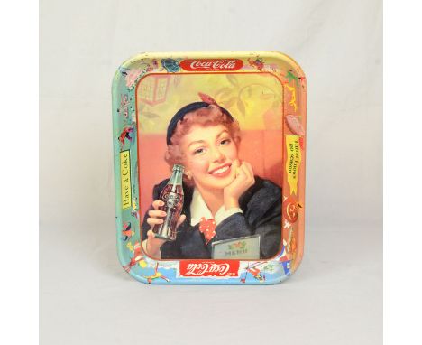 1950's tray depicting a woman drinking a bottle of Coke surrounded by sporting figures on the rim. Tray in very good conditio
