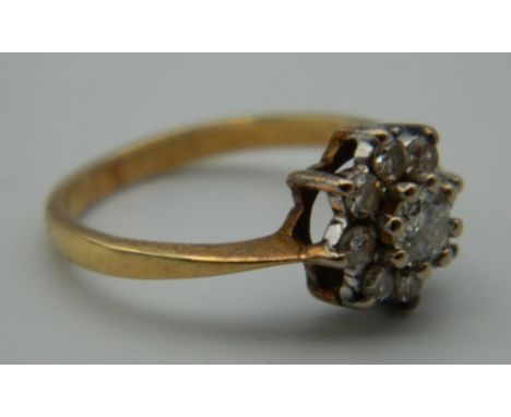 A 9 ct gold stone set flower head ring. Ring Size K. 2.6 grammes total weight.