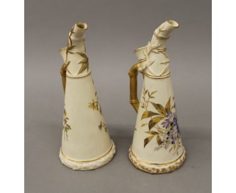 Two Royal Worcester blush ivory ewers. Each 23 cm high.