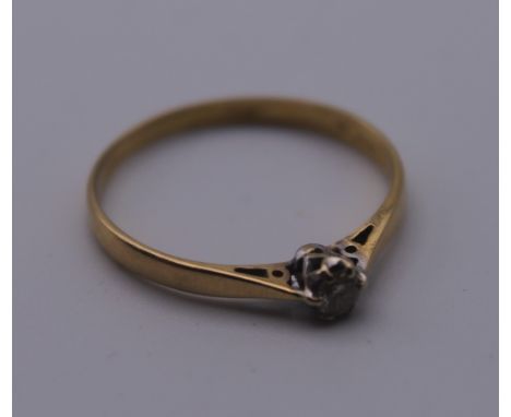 An 18 ct gold diamond solitaire ring. Ring Size R/S. 1.7 grammes total weight.