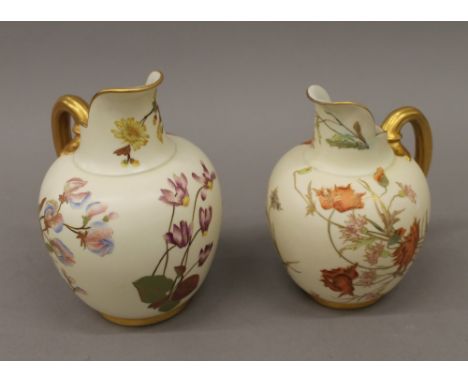 Two large Royal Worcester blush ivory florally decorated jugs. The largest 21 cm high.