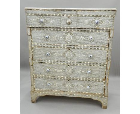 A Syrian mother-of-pearl inlaid chest of drawers with associated marble top. 115 cm wide x 137 cm high. The property of Germa