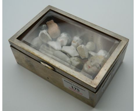 A collection of small Victorian ceramic doll heads. The smallest 2 cm high.