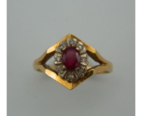 An 18 ct gold diamond and ruby ring. Ring Size O. 4.7 grammes total weight.