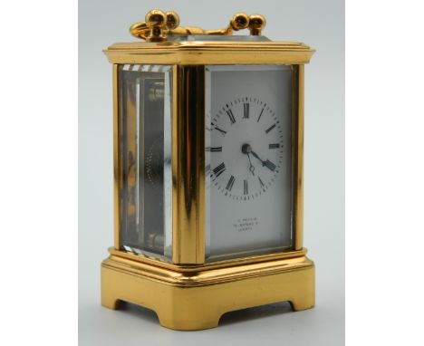 A miniature Antique carriage clock with brass and panelled glass case, with enamel dial inscribed ''H Pearce 74 Oxford St Lon