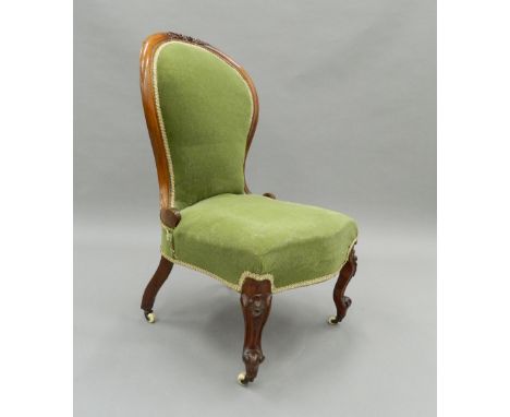 A Victorian mahogany spoon back nursing chair. 50 cm wide.