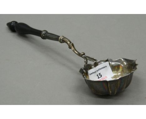 A Georgian silver toddy ladle, with turned wooden handle. 29 cm long. 