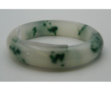 A jade bangle. 7.5 cm diameter.