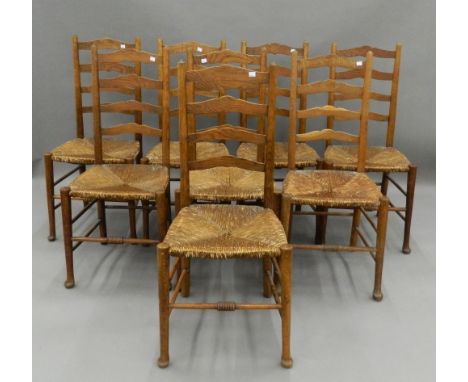 A set of eight early 20th century rush seated ladder back chairs. 43.5 cm wide. The property of Germaine Greer.