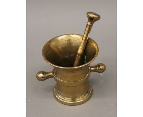 An 18th century bronze pestle and mortar. The latter 12.5 cm high.