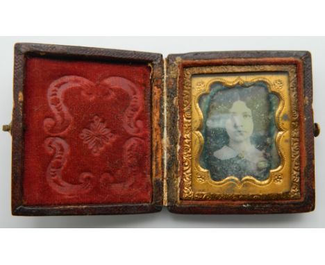 A small leather cased daguerreotype portrait of a girl. 5 cm high.