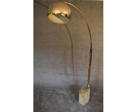 A large floor standing angle poise lamp with marble base and square section brass arm with large brass coloured metal shade. 